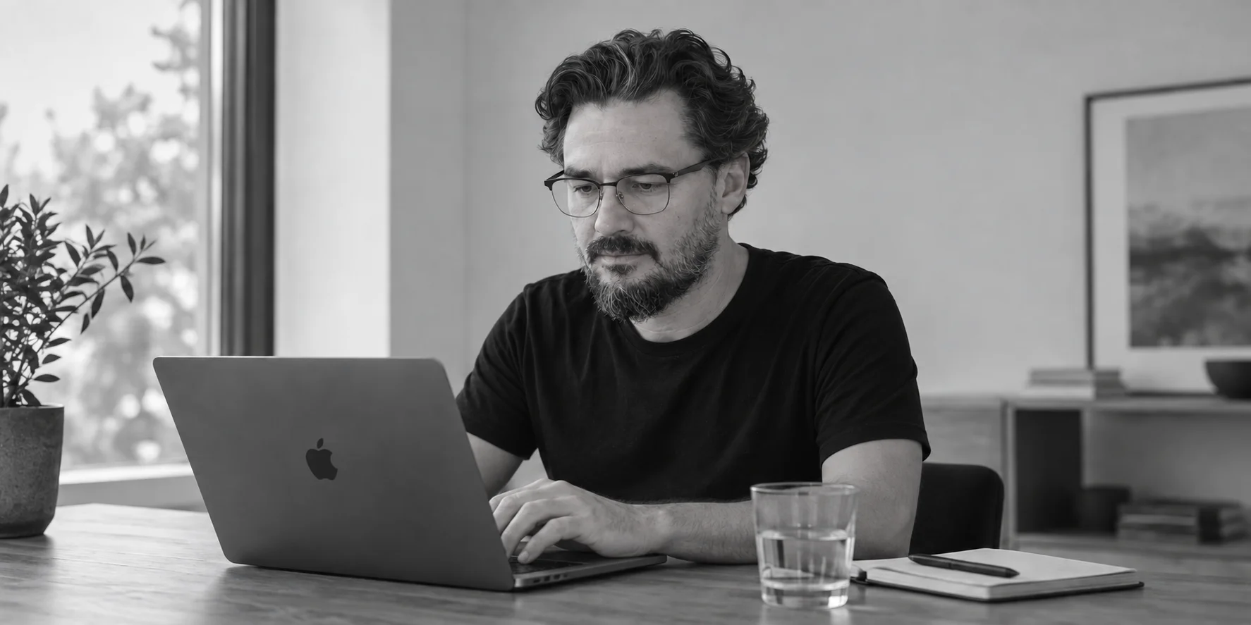AI-generated portrait of Stefan Szakal working at a laptop in a sunlit workspace.
