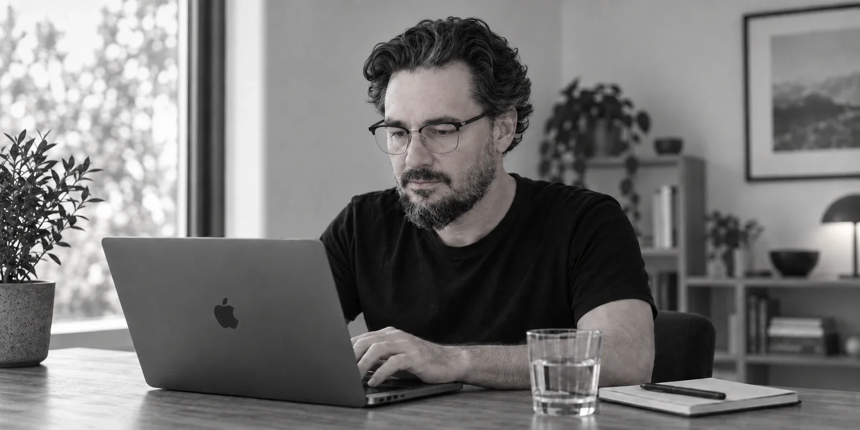 AI-generated portrait of Stefan Szakal working at a laptop in a sunlit workspace.